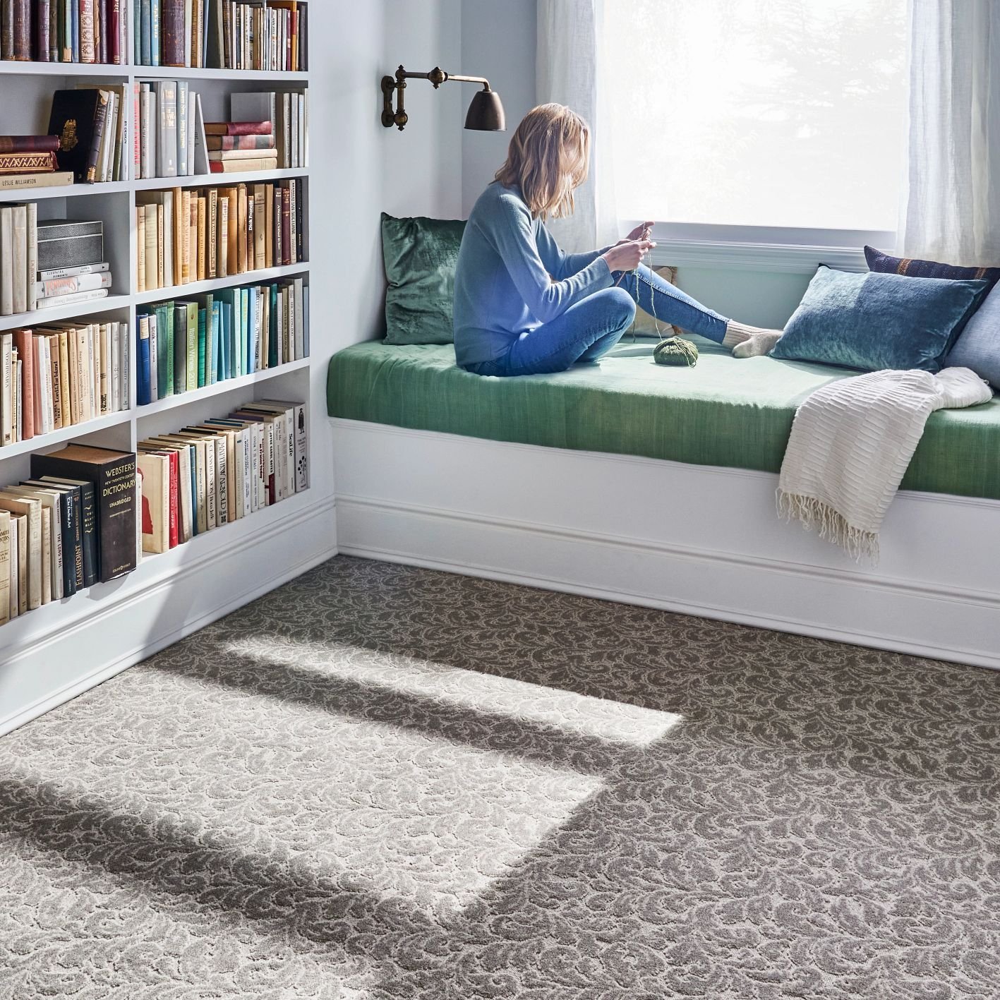 girl reading in a bedroom with white furniture and light brown carpet from May's Lone Star Flooring on Atlanta, TX area