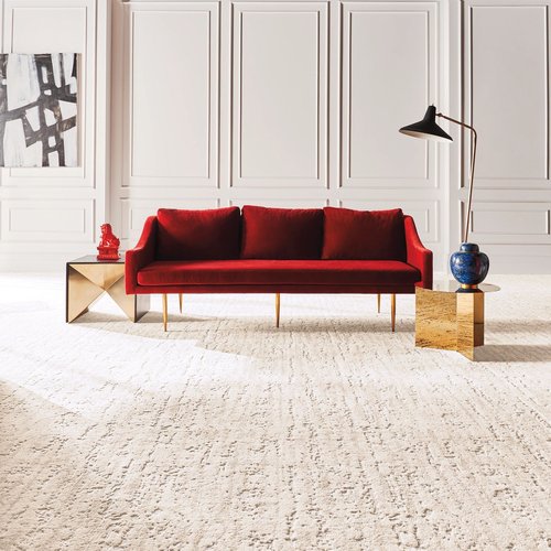 A red couch on a white carpet from May's Lone Star Flooring in Atlanta